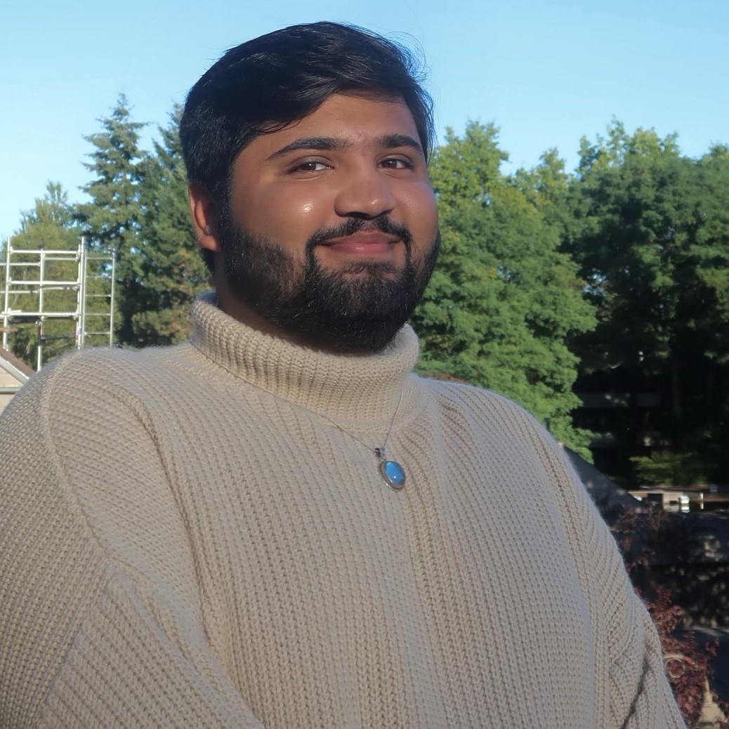 Man in sweater among trees and buildings