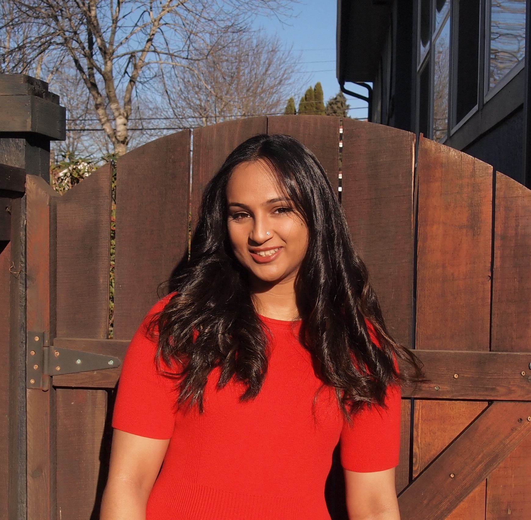 Woman in front of house's gate