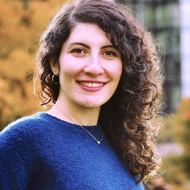 Woman in sweater in city park