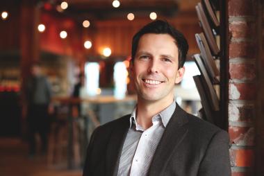 Man in blazer, in restaurant-like room