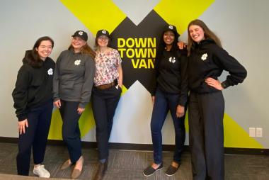 5 SCARP students leaning against a Downtown Van logo