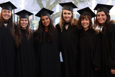 SCARP grads in regalia, arm-in-arm
