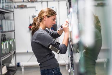 A woman writing on a whiteboard