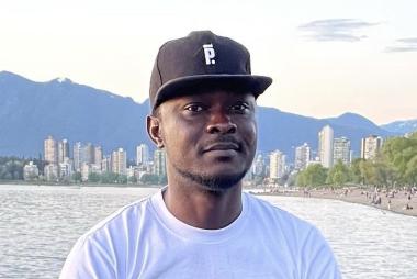 Man at False Creek, in t-shirt and baseball cap