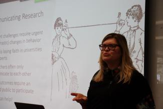 Kelly, presenting slide showing two Victorian women with can-and-strings phone