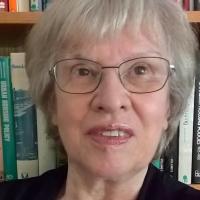 Ann, with shelf of books behind her