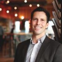 Scott, in Blazer in dimly lit room