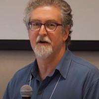 Michael, speaking into a microphone